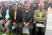 Amcu president Joseph Mathunjwa, right, with  mourners and family members of the six mine workers who died in a fire underground, during a  memorial service  in Phalaborwa, Limpopo, yesterday.