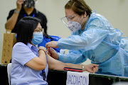 A health worker conducts mock vaccination during a simulation exercise for the coronavirus disease (Covid-19) vaccination activities, at the Universidad de Manila, in Manila, Philippines, January 19, 2021. 