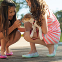 Two girls holding dogs