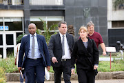 EnviroServ Group technical director Esme Gaumbalt and Chief Executive Dean Thompson along with a member of the EnviroServ  legal team, stride away from the Durban Magistrate's court. They along with two other senior managers have been charged in their personal capacity for contravening the air quality legislation. 