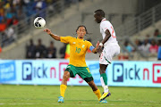 Steven Pienaar ( l) beats Babacar Seck during the International Friendly match between South Africa and Senegal at Moses Mabhida Stadium on February 29, 2012 in Durban, South Africa.