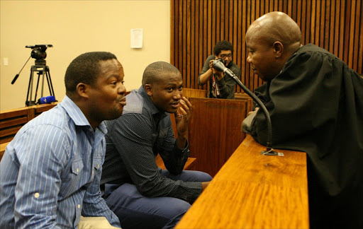 Police officers Mduduzi Nzuza and Sam Baloyi during their brief appearance in the Randburg magistrate's court for allegedly shooting musician Khuli Chana last year. Picture Credit: Mohau Mofokeng, Sowetan