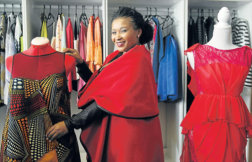 SMART DRESS-REHEARSAL: Fashion designer Sandisiwe Dani of SandiDani Creations with examples of her work. She is one of 10 designers who will be exhibiting their work at the first East London Fashion Walk next monthPicture: SIBONGILE NGALWA