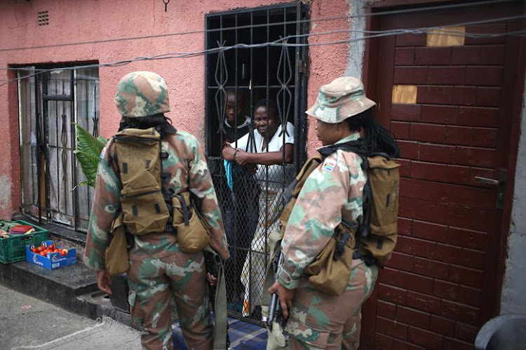 Police officers and members of the SANDF patrol the streets of Alexandra amid the nationwide lockdown.