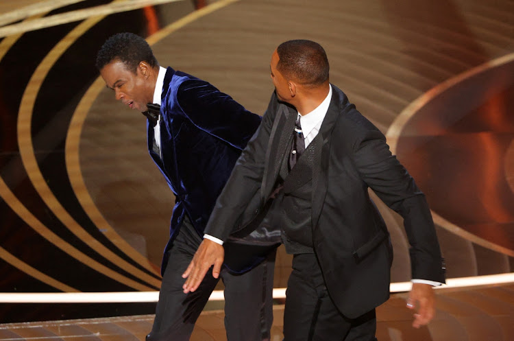Will Smith, right, hits Chris Rock as Rock spoke on stage during the 94th Academy Awards in Hollywood, the US, on March 27. Picture: REUTERS/BRIAN SNYDER