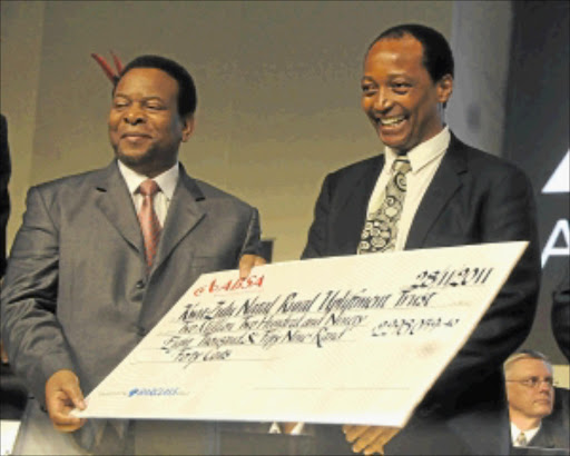 OPEN-HANDED: African Rainbow Minerals executive chairman Patrice Motsepe, right, presents Zulu king Goodwill Zwelithini with a cheque at the Sandton Convention Centre yesterday. PHOTO: VATHISWA RUSELO