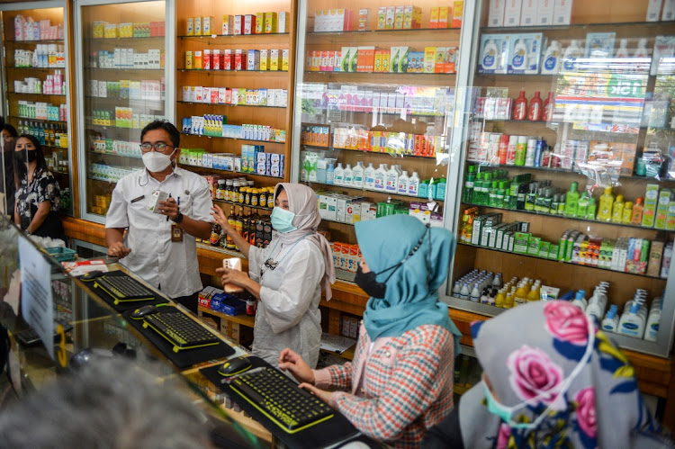 Health officers inspect medicinal syrups containing Êethylene glycol and diethylene glycol at a pharmacy in Bandung, West Java province, Indonesia.