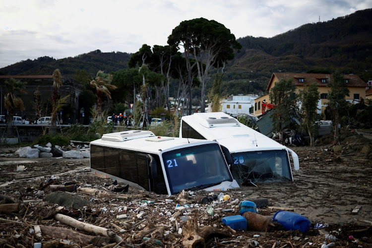 Damaged buses lie among the debris following a landslide on the Italian holiday island of Ischia, November 27 2022. Picture: GUGLIELMO MANGIOPANE/REUTERS