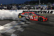 Martin Truex Jr., driver of the #19 Bass Pro Toyota, celebrates with a burnout after winning the NASCAR Cup Series Blue-Emu Maximum Pain Relief 500 at Martinsville Speedway on April 11, 2021 in Martinsville, Virginia.