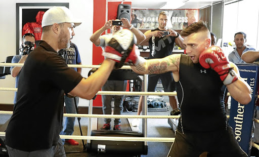 IBO cruiserweight champion Kevin 'Two Guns' Lerena on pads with trainer Peter Smith. / Nick Lourens