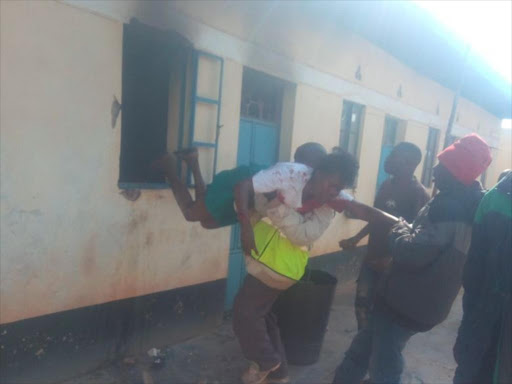 Residents rescue a woman following a domestic dispute with her husband at Ngoluni, Makueni county, December 6, 2017. /MUTUA KAMETI