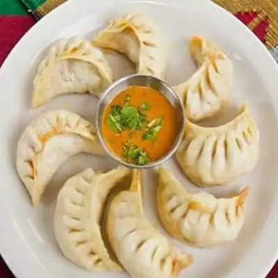 Steamed Chicken Wonder Momo With Kung Pao Sauce