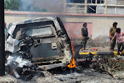 Policemen stand at the scene of a blast in Aden, Yemen, October 10, 2021. 