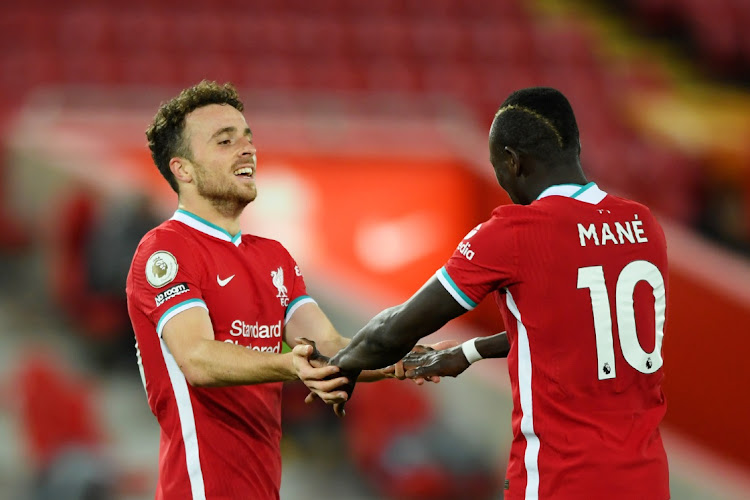 Diogo Jota of Liverpool celebrates scoring with teammate Sadio Mane in the EPL match against Sheffield United at Anfield in Liverpool, on October 24 2020