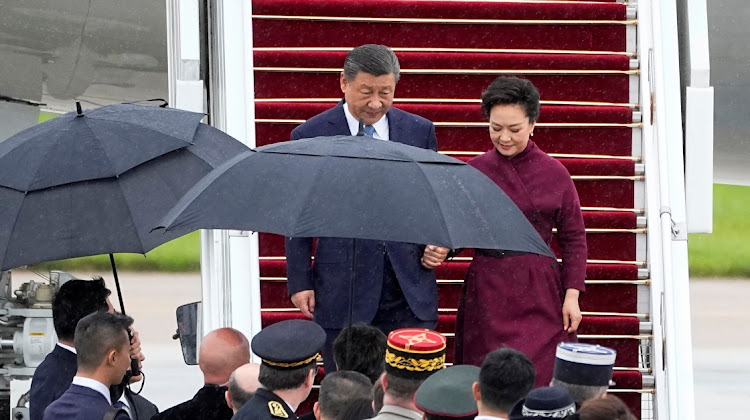 French officials watch China’s President Xi Jinping and his wife Peng Liyuan arrive at Orly Airport, south of Paris, France, May 5 2024. Picture: Michel Euler/Reuters