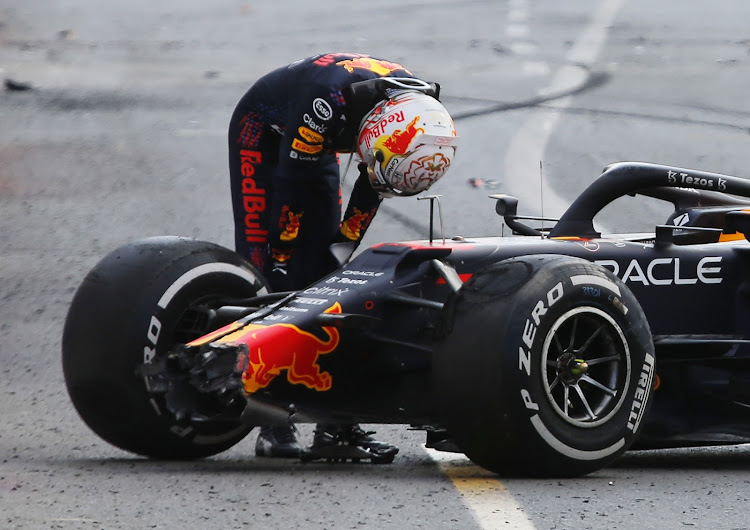 Red Bull's Max Verstappen looks dejected next to his car after crashing out of the Azerbaijan Grand Prix