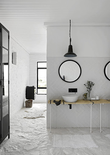 The counter in this modern bathroom has been fashioned from reeds found on the farm.