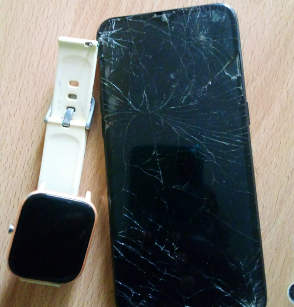 Odanga's mobile phone and smart watch that was damaged by his attackers.