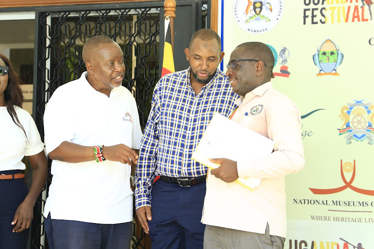 Kenya Coast Tourists Association chairman Victor Shitakha, Mombasa County Tourism Executive Osman Mohamed and Uganda Consul General in Mombasa Ambassador Paul Mukumbya during the launch of the Uganda Festival at Uganda Consulate in Mombasa on Wednesday.