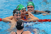 Tatjana Schoenmaker is congratulated by Lilly King, Annie Lazor and Kaylene Corbett after winning the gold medal and breaking the world record in the women's 200m breaststroke final 