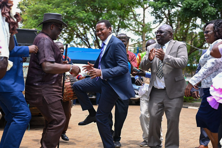 Bungoma Governor Ken Lusaka and Tourism and Wildlife CS Alfred Mutua break into a jig during the CS's tour of Bungoma on March 27, 2024.