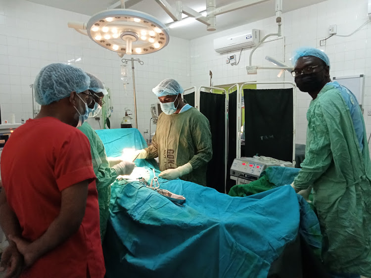 Ophthalmologists operate on a cataract patient during a free eye clinic at the King Fahad Hospital in Lamu