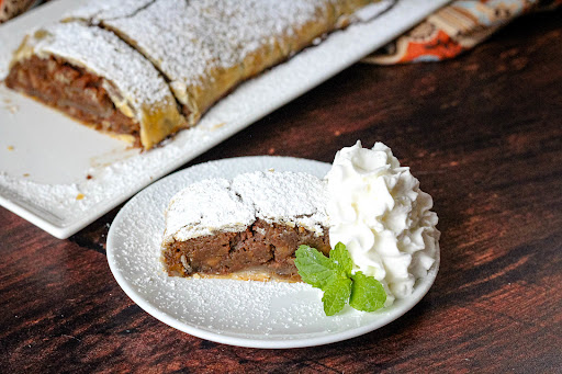 A slice of Leftover Sweet Potato Strudel with whipped cream.