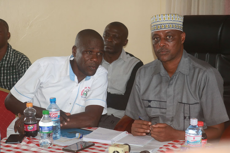 Mombasa County Tuktuk Oganizations chair Benjamin Ochwango and county commissioner Abdirisack Jaldesa at Uhuru na Kazi in Mombasa on Tuesday.