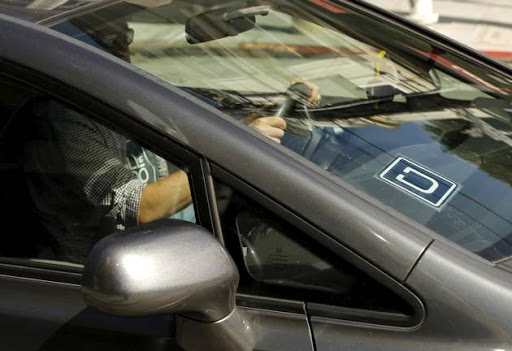 The logo for Uber is shown on a vehicle.