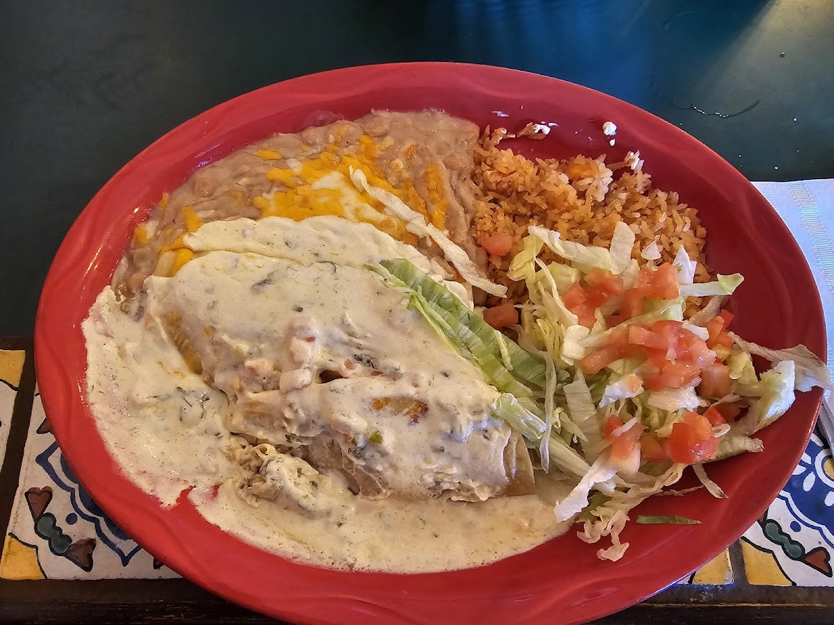 Seafood enchilada with corn tortilla.