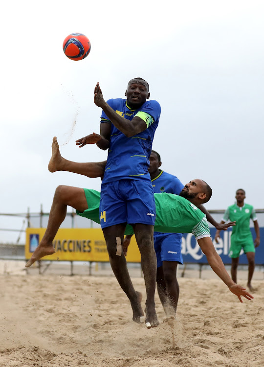 Ammar Ali Said of Comoros and captain of Tanzania Ismail Gambo fight for a ball during the COSAFA Beach Soccer Tournament in Durban.