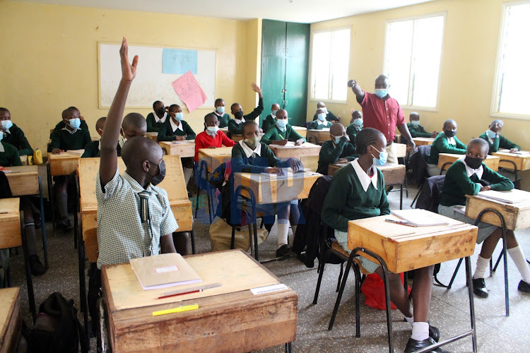 Pupils during a Kiswahili lesson on their first day in class eight as schools opened for a new term at Westlands Primary School, Nairobi on July 26, 2021.