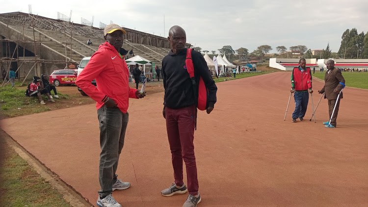 Abraham Cheruiyot Tarbei (in black hood) and Henry Kirwa over the weekend at the Kenya National Paralympics Committee trials at the Kipchoge Keino stadium in Eldoret.