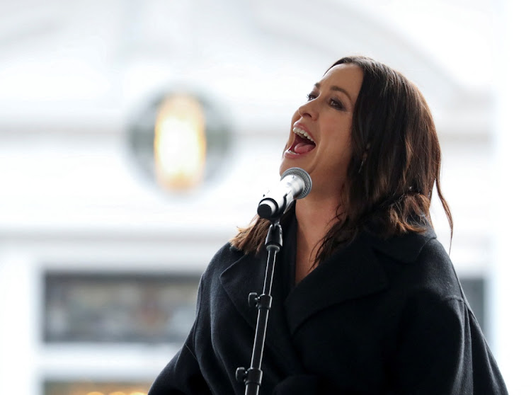 Alanis Morissette performs during the public memorial at Graceland mansion.