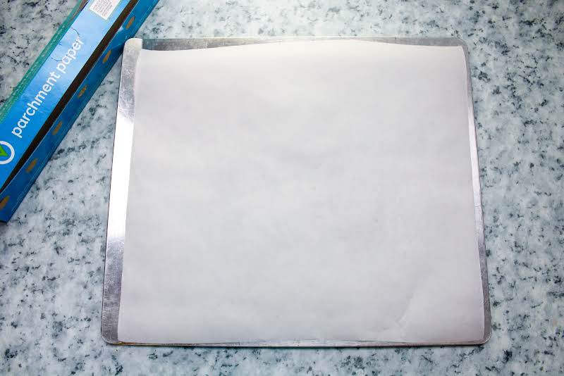 Lining A Baking Sheet With Parchment Paper.