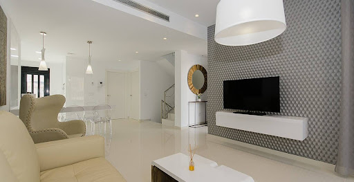 Modern living room with sofa and wall-mounted TV - Prestige property for sale in Dehesa de Campoamor, 4 rooms, 4 bedrooms