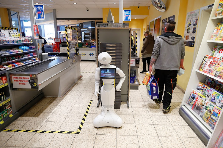 Humanoid robot Prepper is standing at the checkout counter of the Edeka grocery store to explain protective measures and to promote solidarity with each other, as the spread of the coronavirus disease (COVID-19) continues, in Lindlar, Germany, March 31, 2020. File photo