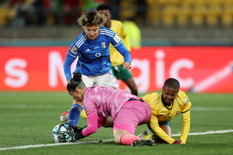 Banyana Banyana goalkeeper Kaylin Swart saves at the feet of Italy's Valentina Giacinti while Bambanani Mbane also challenges in their Women's World Cup group G match at Wellington Regional Stadium on August 2 2023.