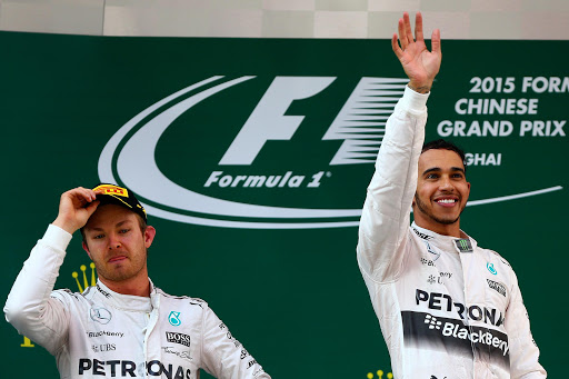 SHANGHAI, CHINA - APRIL 12: Lewis Hamilton of Great Britain and Mercedes GP celebrates on the podium next to Nico Rosberg of Germany and Mercedes GP after winning the Formula One Grand Prix of China at Shanghai International Circuit on April 12, 2015 in Shanghai, China. (Photo by Dan Istitene/Getty Images)