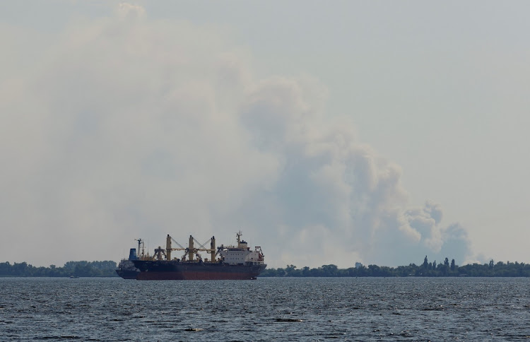 Smoke rises behind vessels on the Dnipro River during Ukraine-Russia conflict in the Russia-controlled city of Kherson, Ukraine, in this July 24 2022 file photo. REUTERS/ALEXANDER ERMOCHENKO