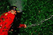 Race winner Charles Leclerc celebrates on the podium during the F1 Grand Prix of Australia at Melbourne Grand Prix Circuit on April 10, 2022 in Melbourne, Australia.