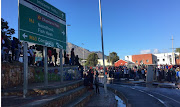 Protesters mass at the traffic circle at the entrance to Hout Bay on Monday morning.