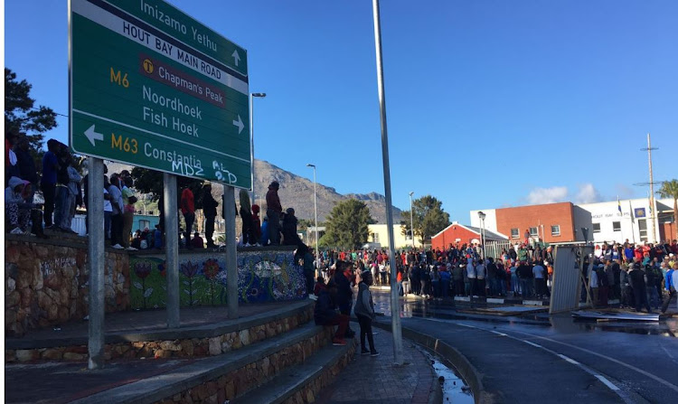 Protesters mass at the traffic circle at the entrance to Hout Bay on Monday morning.