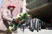 MEC of Health Bandile Masuku lays a wreath commemorating the three firefighters that died at the Bank of Lisbon building last year. 