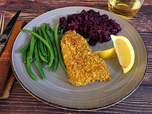 A delicious well-seasoned Cornflake Crusted Fish along with red cabbage and green beans.