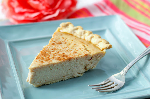 A slice of ricotta pie on a plate.