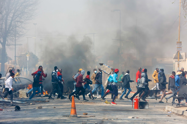 At least four people were killed, a municipal building was torched and more than 10 cars set alight during protests in Tembisa. Picture: THULANI MBELE