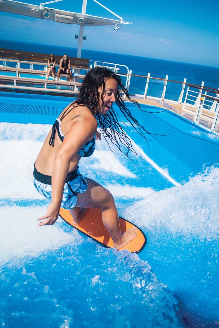 An instructor shows some rad moves on the FlowRider surf simulator on Harmony of the Seas.