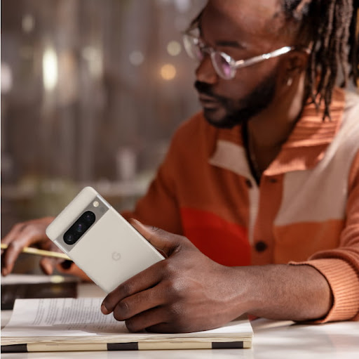 A man using a Google Pixel 8 phone to work.