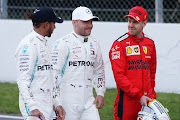 Sebastian Vettel of Ferrari, right, speaks with Mercedes AMG Petronas drivers Valtteri Bottas, centre, and Lewis Hamilton during day one of Formula 1 Winter Testing at Circuit de Barcelona-Catalunya on February 19 2020 in Barcelona, Spain.